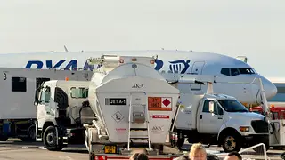 Airliner being refuelled from a fuel truck at the gate