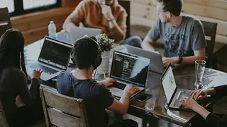 Group working around one laptop