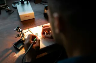 Person holding a coated wire