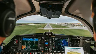 Pilots in the cockpit by day