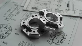 Metal parts on engineering blueprints
