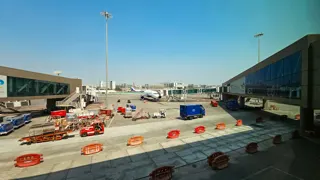 Aircraft at a gate with ground vehicles