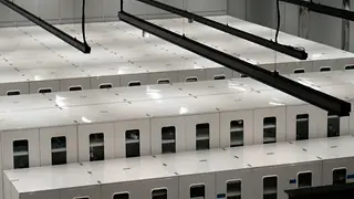 Modern data centre with rows of white server cabinets